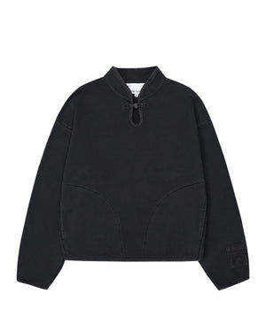 Introducing the BLACK TEARDROP KNOT SWEATSHIRT from Sundae School—a minimalist, loose-fitting pullover crafted from 100% cotton. This black sweatshirt features long sleeves, a high collar with a front drawstring tie, curved seam details on the front, and a small patch adorning the left sleeve.