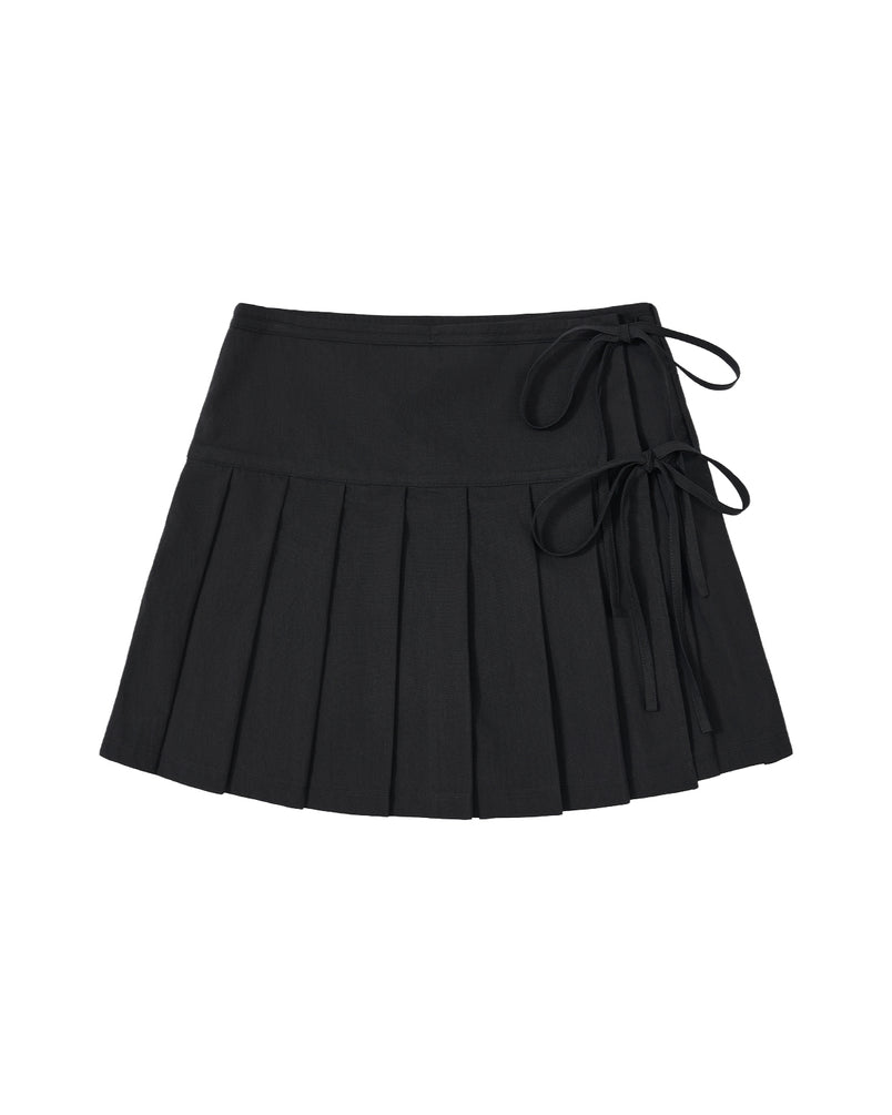 Introducing the BLACK UNIFORM APRON SKIRT by Sundae School—a black pleated mini skirt inspired by the sleek design of a Korean pleated apron. This modern piece features two ribbon tie accents on the right, a fitted waistband, and a flared, structured silhouette for a contemporary take on classic workwear style.