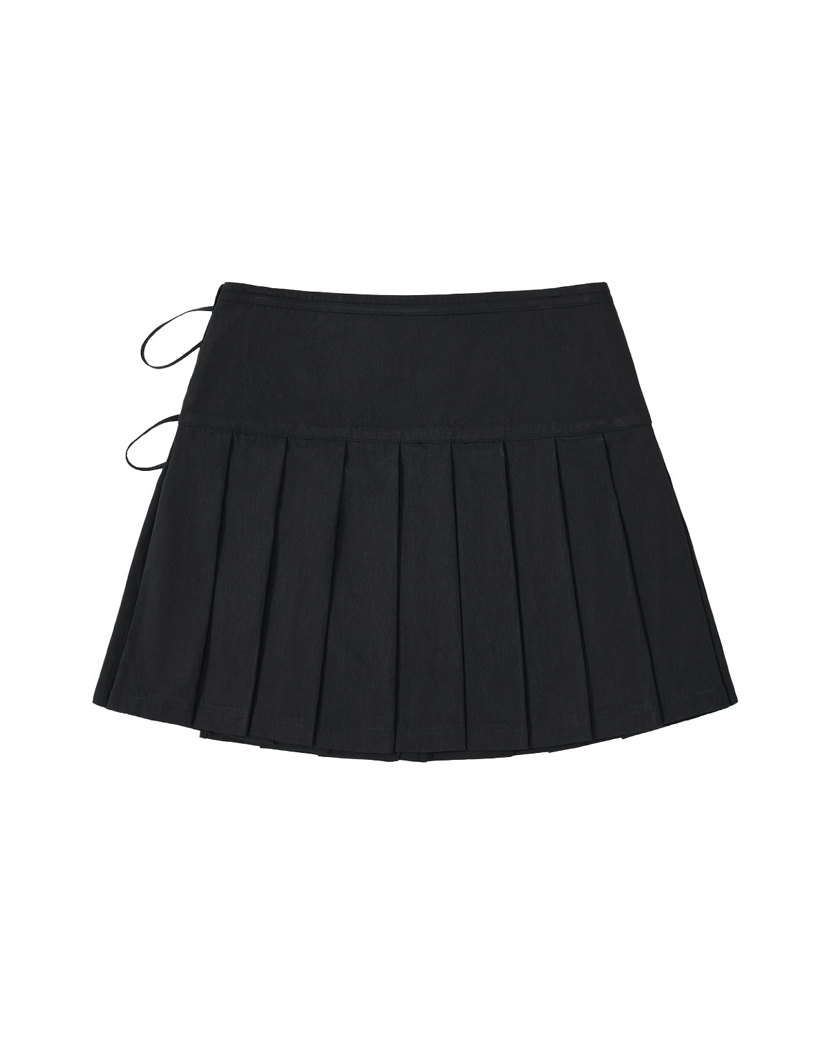 The BLACK UNIFORM APRON SKIRT by Sundae School is a black pleated mini skirt featuring a fitted waistband and two thin black straps on the left side, inspired by the style of a Korean pleated apron. The skirt is shown laid flat on a white background.