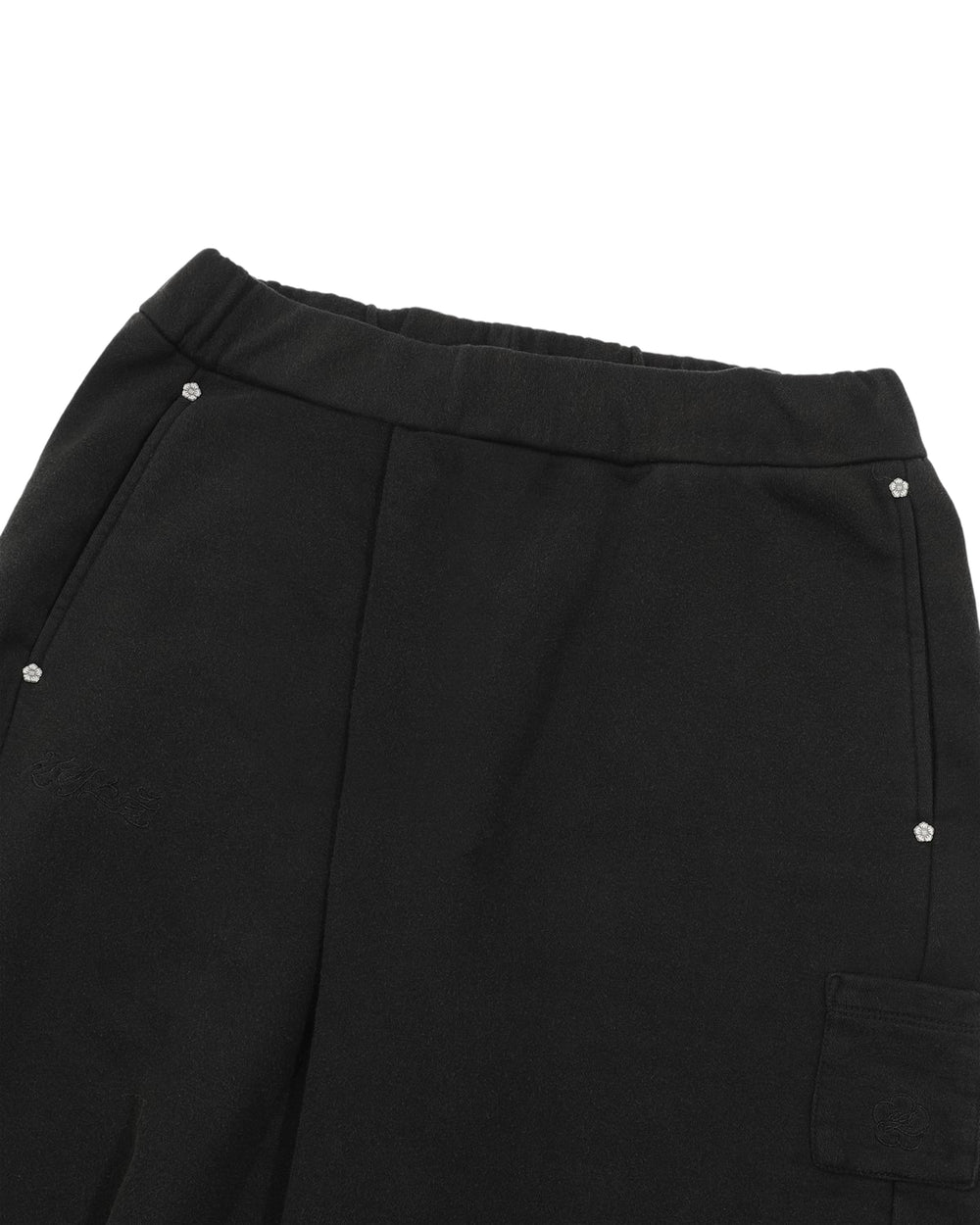 Introducing the BLACK WASH WRAP SWEAT BAJI by Sundae School: unisex black pants crafted with an elastic waistband, two side pockets accented with subtle rhinestone embellishments, and a flap pocket on the thigh. Reminiscent of classic joggers, these sweat baji feature a soft, lightly textured fabric for comfortable everyday wear.