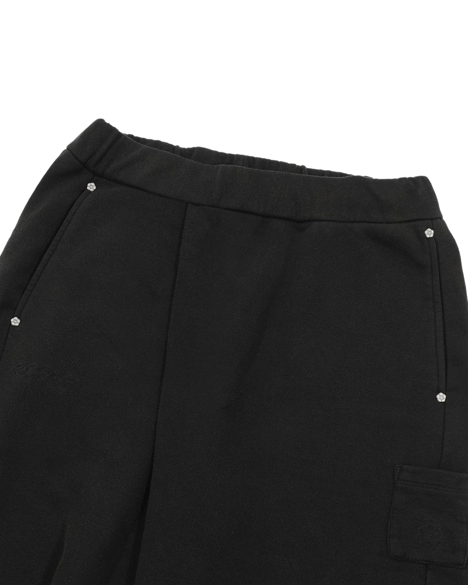 Introducing the BLACK WASH WRAP SWEAT BAJI by Sundae School: unisex black pants crafted with an elastic waistband, two side pockets accented with subtle rhinestone embellishments, and a flap pocket on the thigh. Reminiscent of classic joggers, these sweat baji feature a soft, lightly textured fabric for comfortable everyday wear.